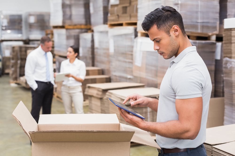 Portrait of male manager using digital tablet in warehouse